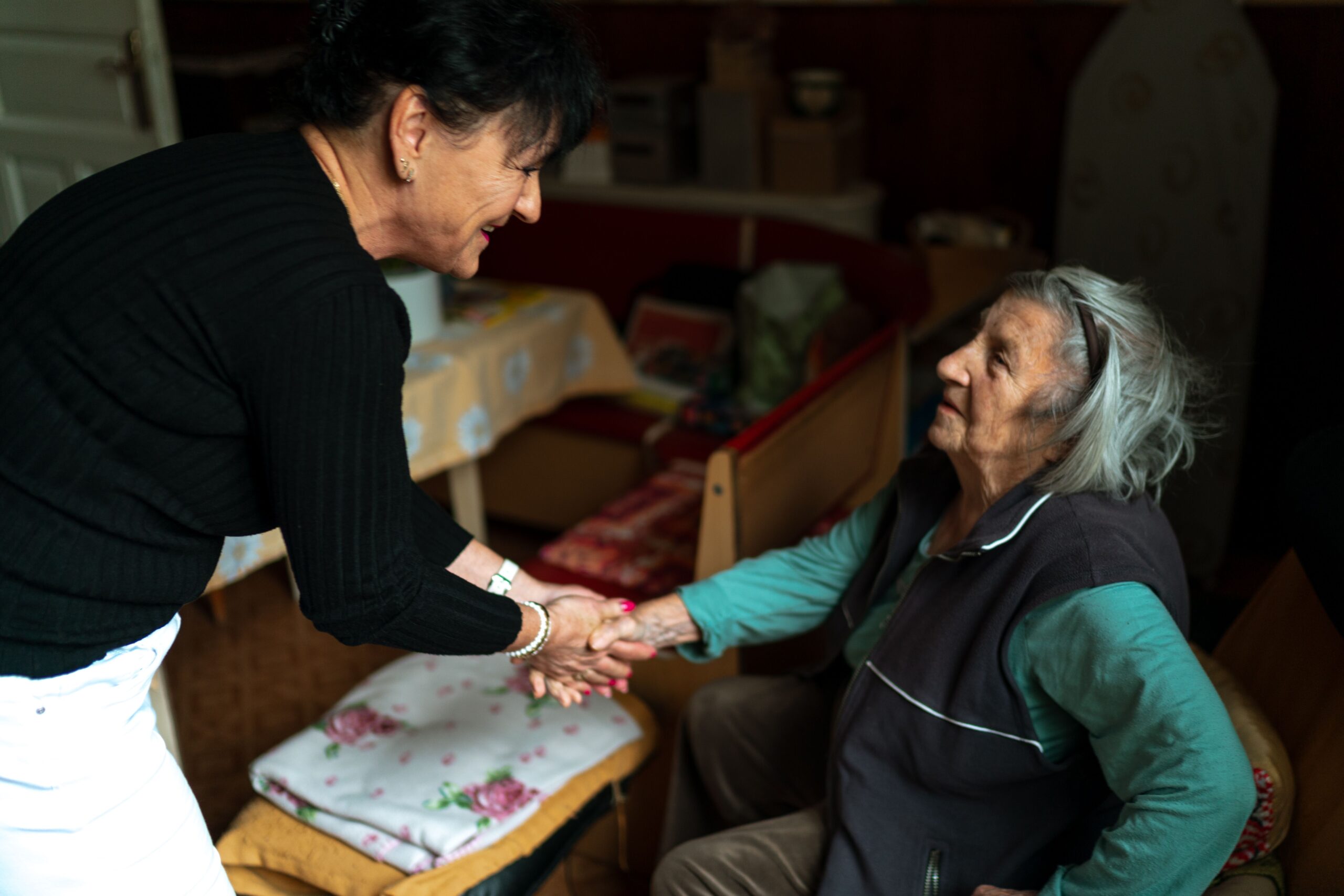 Caregiver greeting a client at home